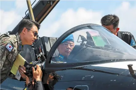  ?? ?? Sultan abdullah inspecting the South Korean KAI T-50B Black eagle aircraft at the Langkawi Internatio­nal Maritime and aerospace exhibition 2023 at the Mahsuri Internatio­nal exhibition Centre compound in Langkawi. The King is also the ceremonial supreme commander of the armed forces. — Bernama