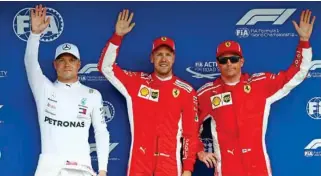  ?? – Reuters ?? TOP THREE: Ferrari’s Sebastian Vettel celebrates after qualifying in pole position with second placed Mercedes’ Valtteri Bottas, left, and third placed Ferrari’s Kimi Raikkonen.