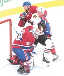  ?? AP ?? Canadiens defenseman Jeff Petry pushes Hawks forward David Kampf into goalie Charlie Lindgren during the second period Wednesday.