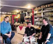  ?? R. Clayton McKee / For the Chronicle ?? Daniel Ornelas of the Ol’ Railroad Cafe and Mike Mercado of BR Vino talk with Rosenberg Main Street manager Dan Kelleher about an upcoming event. Kelleher says that much of his job involves visiting merchants and officials and meeting visitors.