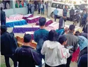  ?? — PTI ?? Locals and relatives stand near the bodies of 13 people who were allegedly killed by Armed Forces in Mon district, Nagaland, on Sunday.