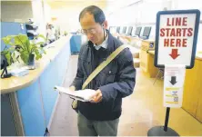  ?? Paul Chinn / The Chronicle ?? Simon Chan reviews his paperwork after discoverin­g that he was inadverten­tly charged tuition fees when registerin­g.