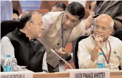  ?? —PTI ?? Union finance minister Arun Jaitley listens to Chief economic advisor Arvind Subramania­m as minister of state for finance Shiv Pratap Shukla looks on, at the 22nd meeting of the GST council, in New Delhi on Friday.