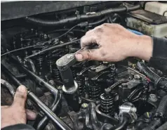  ??  ?? There are a number of different ways to remove the actual injectors, which are press-fitted into the cylinder head. Quezada used a simple and well-used $30 injector puller to do the job. The valve covers were removed for an unrelated head-bolt retorquing article (See Diesel World’s Feb. 2019 issue)