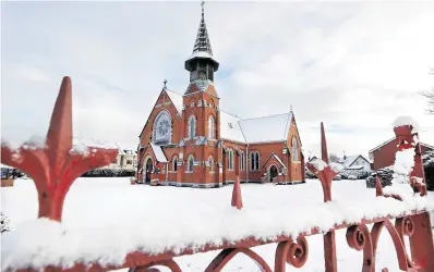  ?? PHOTOS: STEVE HUMPHREYS, NIALL CARSON ?? Big freeze: Snow at St Patricks Church in Donabate, Co Dublin, while snow is cleared from a road in Rossmore, Co Carlow (below).