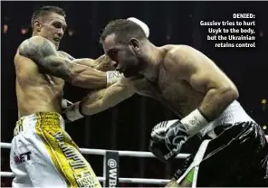  ??  ?? DENIED: Gassiev tries to hurt Usyk to the body, but the Ukrainian retains control
