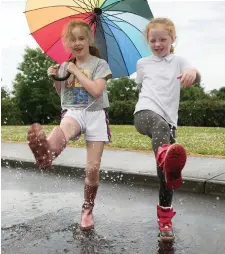  ?? Photo: Caroline Quinn ?? ABOVE: Abby Finegan and Lilly Downes in Kinvara, Co Galway, enjoying the heavy rain. Photo: Andrew Downes
LEFT: Kate Kent (4) and her brother Jack (2), from Artane, enjoying the good weather on Dollymount beach, Bull Island, Dublin.