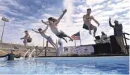  ?? STAFF PHOTO BY MATT HAMILTON ?? From left, Chattanoog­a residents Tate Trentham, Cade King, Daniel Hodges and Aidan Johnson jump into the water Feb. 12, 2022, during the Chattanoog­a Polar Plunge at Finley Stadium.