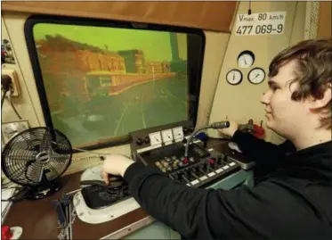  ?? MICHAEL SOHN — THE ASSOCIATED PRESS ?? In this Friday photo Tobias Hirsch of the ‘Historic City Train Driving Simulator’ poses in the simulator cockpit in Berlin, Germany.