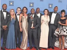  ?? ASSOCIATED PRESS ?? The cast and crew of “Moonlight” pose with the Golden Globe for best film, drama.