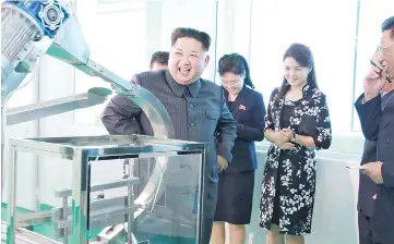  ??  ?? This undated picture released from North Korea’s official Korean Central News Agency (KCNA) shows Kim (left) inspecting the Pyongyang Cosmetics Factory, as his wife Ri Sol-Ju (second right) looks on. — AFP photo