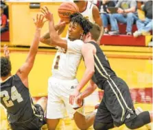  ?? STAFF PHOTO BY TIM BARBER ?? Tyner’s Jeremy Elsotn gains control of the ball from Upperman’s Isaiah Allen, left, and Jaydon Kanipe during Monday’s sectional game at Tyner.