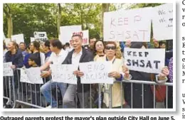  ??  ?? Outraged parents protest the mayor's plan outside City Hall on June 5.