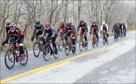  ?? NWA Democrat-Gazette/FLIP PUTTHOFF ?? A pack of riders heads south between West Fork and Winslow on U.S. 71. The highway is popular for biking now that most traffic is on adjacent Interstate 49.