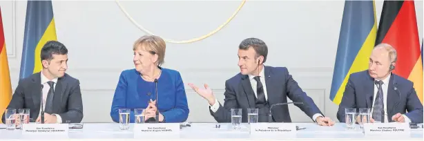  ?? AP ?? Ukraine’s President Volodymyr Zelenskiy, left, German Chancellor Angela Merkel, French President Emmanuel Macron and Russian President Vladimir Putin, right, at a news conference in Paris.