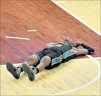  ?? AP ?? Memphis Grizzlies guard Ja Morant lies on the court during the second half of a game against the Phoenix Suns on Monday in Memphis, Tenn.