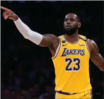  ?? (AP file photo) ?? LeBron James, who guided the Los Angeles Lakers to the NBA title while leading the league in scoring and assists, is The Associated Press Male Athlete of the Year for a record-tying fourth time.