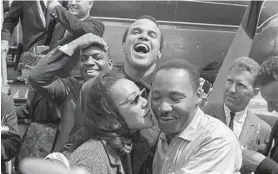  ?? IVAN MASSAR/TAKE STOCK/THE IMAGE WORKS/HBO VIA AP ?? Martin Luther King Jr. receives a kiss from his wife in this 1963 image released by HBO.