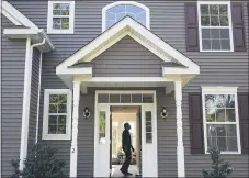  ?? JOHN MINCHILLO — THE ASSOCIATED PRESS FILE PHOTO ?? A homeowner tours their new home, in Washington­ville, N.Y. When it comes to buying a home, it’s common to focus all your saving efforts on the down payment. But set a savings goal for other homeowners­hip costs, too, especially in that first year.