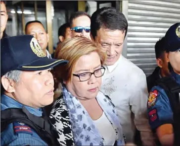  ?? TED ALJIBE/AFP ?? Then-Philippine Senator Leila De Lima (centre), a critic of President Rodrigo Duterte, being escorted by police officers after her arrest at the Senate in Manila on February 24.