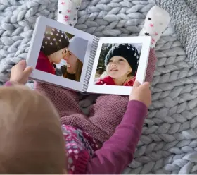  ??  ?? >>
Pixum Fotobücher gibt es in verschiede­nen Größen und Bindungen. Beliebt ist das quadratisc­he Format (hier mit Ringbindun­g).