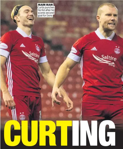  ??  ?? MAIN MAN Curtis punches his fist after he scores second goal for Dons