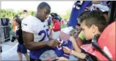  ?? ADRIAN KRAUS — THE ASSOCIATED PRESS ?? Bills running back LeSean McCoy signs autographs at training camp in Pittsford, N.Y., Thursday. for fans