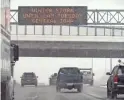  ?? CHARLIE NEIBERGALL/AP ?? Traffic passes a sign warning of a winter storm Monday in Des Moines, Iowa. A major winter storm was expected to blanket a large swath of the middle of the country with snow Monday and disrupt travel as more than a foot of snow was expected to fall in some areas.