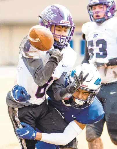  ?? MIKE CAUDILL/FREELANCE ?? Indian River’s Zakai Minggia tackles Deep Creek’s Amarion Harrell, left, during a high school football game Saturday in Chesapeake. The COVID-19 pandemic has already canceled or postponed multiple games after one week of the season.