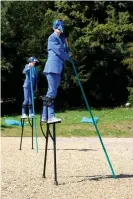  ??  ?? Harbingers … stilt walkers stalk the gardens. Photograph: Joe Low