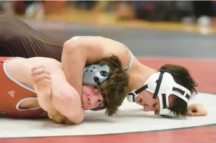  ?? ?? Stanley, top, finishes off Sonne at 132 pounds in the Class 3A Hinsdale Central Sectional championsh­ip match.