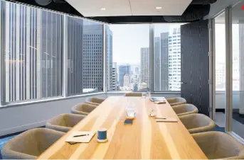  ??  ?? Above, workers can grab a bite or hang out at the Hearth, where jagged wall dividers (designed by Rapt Studio) mimic the city’s hills. In the Embarcader­o conference room, left, which allows for observing the Market Street corridor, the hickory table is...