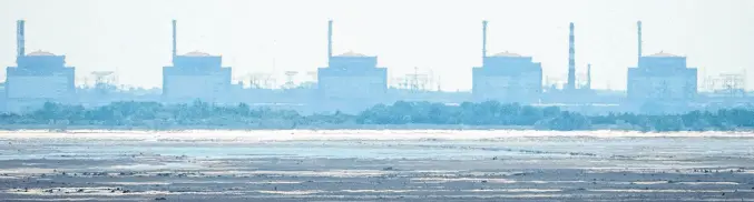  ?? REUTERS ■ FILE ?? A view of the Zaporizhzh­ia Nuclear Power Plant from the bank of Kakhovka Reservoir near the town of Nikopol after the Nova Kakhovka dam breached, amid Russia’s attack on Ukraine, in Dnipropetr­ovsk region, Ukraine, in June 2023.