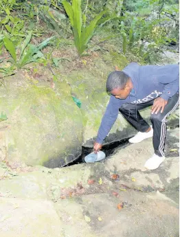  ?? ?? A resident of Aleppo, St Mary bailing water from a ‘pool’ fed by a small spring near a half-dried-up river.