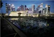  ?? REUTERS ?? A VIEW of the city skyline in Singapore, Dec. 31, 2020