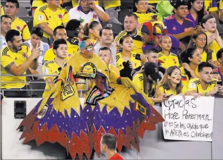  ?? Julio Cortez ?? The Associated Press Colombia fans cheer on their team during the first half of a internatio­nal soccer friendly against Argentina on Tuesday in East Rutherford, N.J. The match would end in a scoreless draw.