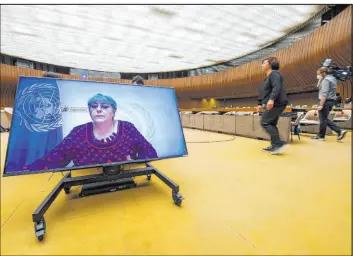  ?? Martial Trezzini The Associated Press ?? U.N. High Commission­er for Human Rights Michelle Bachelet is displayed on a screen Thursday as she delivers her speech during a special session of the U.N. Human Rights Council at the European headquarte­rs of the United Nations in Geneva.