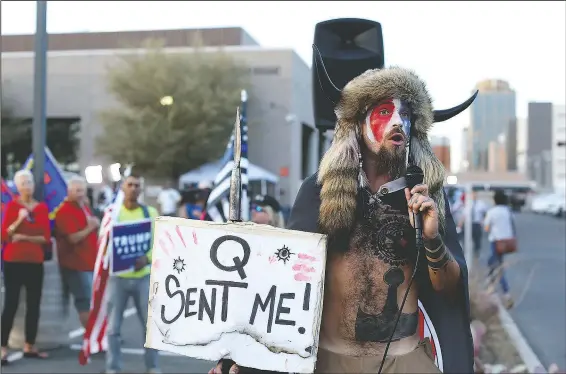  ?? (File Photo/AP/Dario Lopez-Mills) ?? Jacob Anthony Chansley, who also goes by the name Jake Angeli, a QAnon believer, speaks Nov. 5 to a crowd of President Donald Trump supporters outside of the Maricopa County Recorder’s Office where votes in the general election are being counted, in Phoenix.