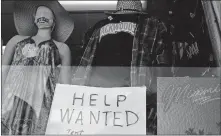  ??  ?? A “Help Wanted,” sign is shown Jan. 7 in the window of a souvenir shop in Miami Beach, Fla. [WILFREDO LEE/ASSOCIATED PRESS FILE PHOTO]