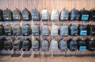  ?? DARRYL DYCK THE CANADIAN PRESS ?? Backpacks are displayed at Herschel Supply Company’s flagship and first North American store, in Vancouver, in June. Parents and students are shelling out hundreds of dollars on school supplies right now.