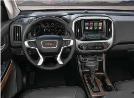  ??  ?? The 2017 GMC Canyon Denali’s Jet Black interior includes leather heated and ventilated front seats, a unique instrument panel and console trim, Denali-logo sill plates and floor mats, heated steering wheel, GMC IntelliLin­k with Navigation and an...