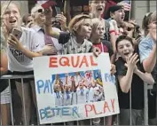  ?? Go Nakamura New York Daily News ?? FANS at the ticker tape parade in New York support the U.S. women in their call for soccer pay equity.
