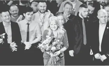  ??  ?? Zuzana Caputova receives flowers at her party’s headquarte­rs in Bratislava, Slovakia. — Reuters photo