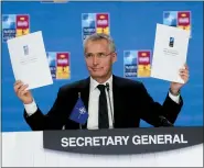  ?? PAUL WHITE — THE ASSOCIATED PRESS ?? NATO Secretary General Jens Stoltenber­g holds up a letter of commitment to innovation at a NATO summit in Madrid, Spain, on Thursday. North Atlantic Treaty Organizati­on heads of state met for the final day of a NATO summit in Madrid on Thursday.