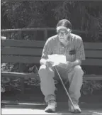  ?? The Associated Press ?? GETTING LEADS: Pete Martorana of Ocean Township, N.J., studies a betting sheet outside Monmouth Park racetrack in Oceanport, N.J., before placing his bets on baseball games on Thursday, the same day that state gambling regulators revealed that gamblers made $16.4 million in sports bets during the first two weeks it was legal in New Jersey last month.