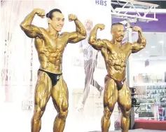  ??  ?? (From right) Buda and Awang Azizul flex for the judges during the ‘Champion of Champion’ showdown.