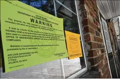  ?? ?? UNINHABITA­BLE
Notices from Atlanta Police Department’s code enforcemen­t section warn that a building at Pavilion Place is not habitable. They were posted in May, seven months after the fire that damaged it. Despite the notices, a new family moved in downstairs.