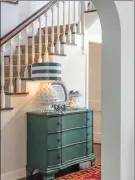  ?? (Bob Greenspan) ?? Placing a chest of drawers in a hallway offers you a spot to put a welcoming lamp and a few fun accents.