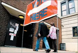  ?? JEFF SWENSEN/GETTY ?? Voters head to the polls Tuesday outside a middle school polling place in Wheeling, W.Va.