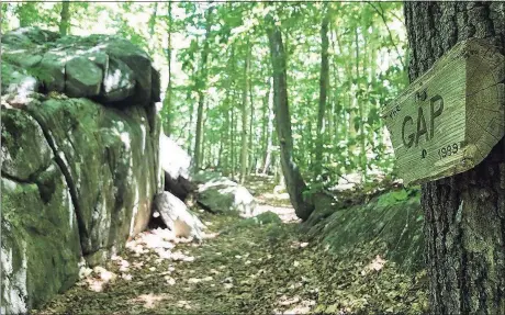  ?? Peter Marteka / Contribute­d photo ?? Between a tall rock formation and trees, “The Gap” has the feeling of a tunnel.